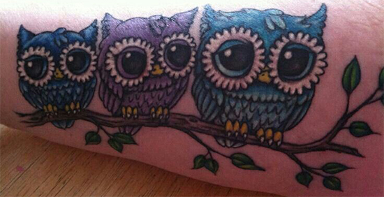 Owl family tattoo on tree