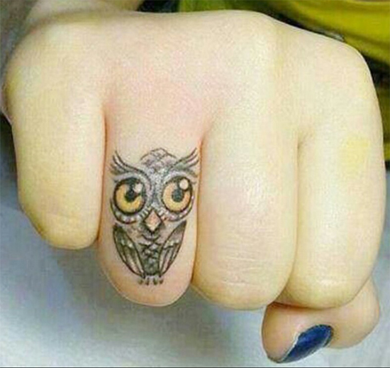 Sweet owl eye tattoo on fingers